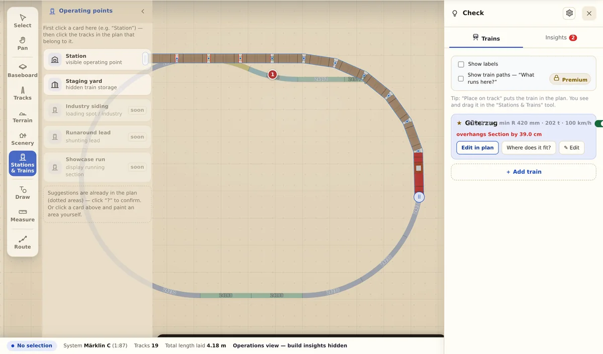 A train sits in the station track while the app compares its length against the usable length of that track.